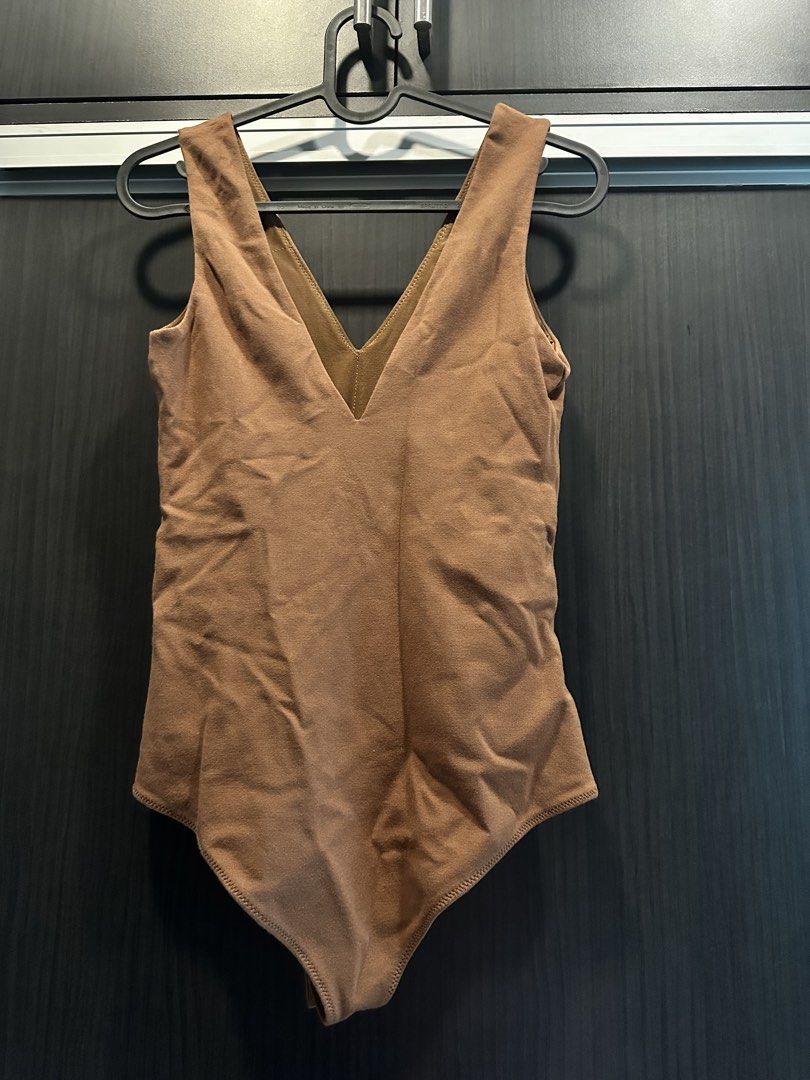 Brown V-neck Sleeveless Bodysuit (Category: Sleeveless) located in Manila. Submitted by cnik8 (Listing ID 1462111782, Image 2). Description: - Brown V-neck bodysuit - Sleeveless design - Quality fabric, stretchy - Padded - With clasp closure at crotch.