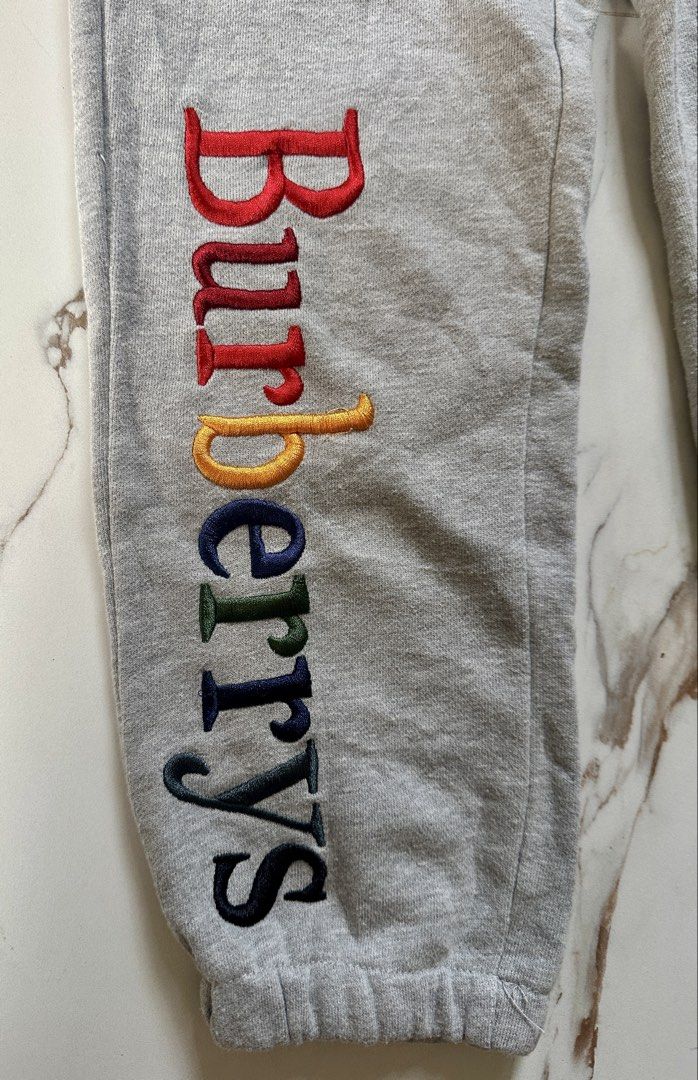 Burberry Brit Grey Sweatpants Rainbow Logo Size S (Category: Joggers) located in Candaba. Submitted by shokgold19 (Listing ID 1462102020, Image 2). Description: - Burberry Brit Grey Sweatpants - Iconic rainbow logo embroidered on left leg - Elastic waistband with drawstring - Made in Turkey - Size S - Ideal for casual wear.