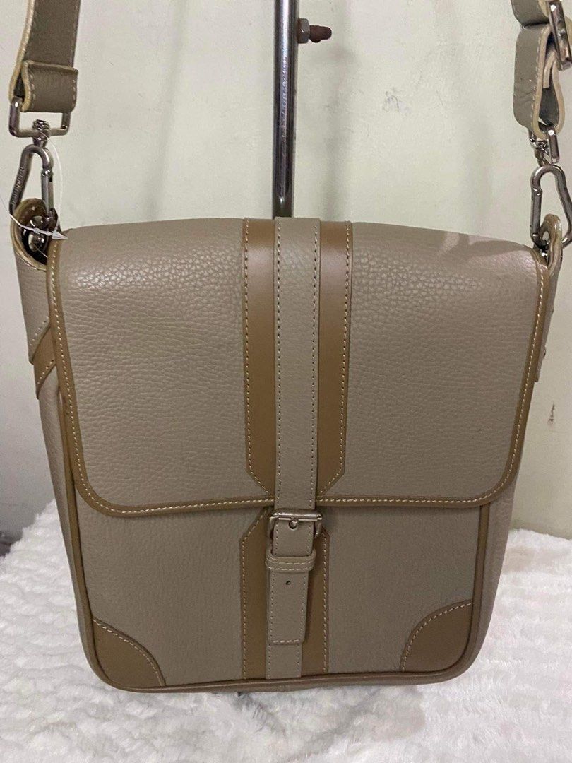 Burberry Leather shoulder bag (Category: Cross-body Bags) located in Tagaytay City. Submitted by melissamm0237 (Listing ID 1462035472, Image 1). Description: - Genuine tan leather shoulder bag (short strap only) - Secure flap closure with silver buckle - Decorative vertical straps on front flap - Contrasting tan trim and corner details - Adjustable shoulder strap with silver hardware - Ideal for everyday use.