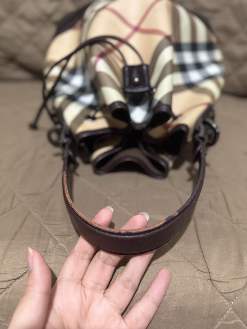 BURBERRY NOVA BUCKET BAG (Category: Luxury Bags & Wallets) located in San Pablo. Submitted by calmhawk.60c993 (Listing ID 1462137463, Image 2). Description: Burberry Nova Check drawstring bucket bag, highlighted by its distinctive dark leather trim and cinch-cord closure... JUST a rubber lining minor issue.