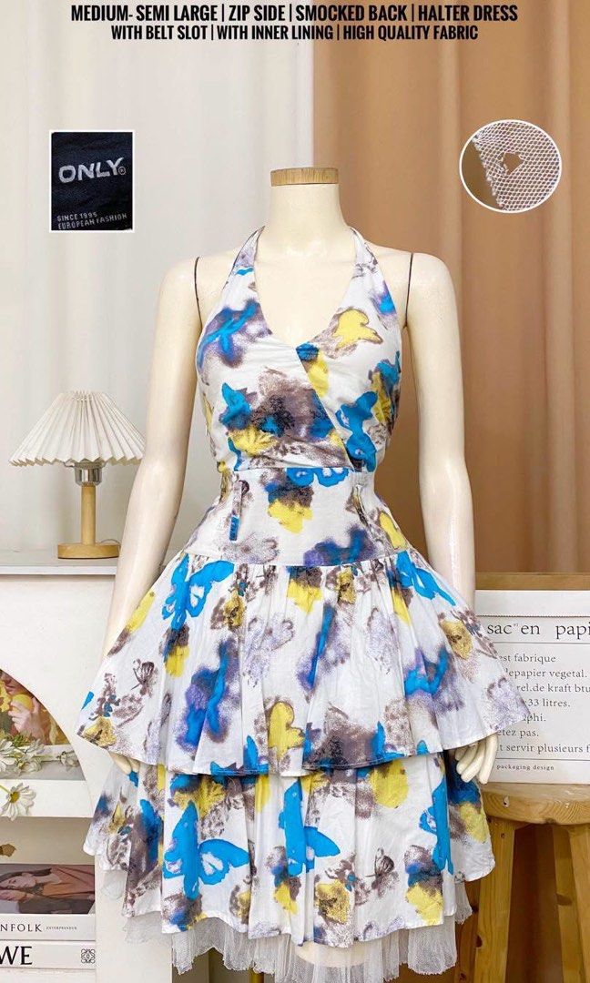 Vibrant Whimsical halter layered dress (Category: Dresses) located in Cavite. Submitted by wishie_collects (Listing ID 1462213678, Image 2). Description: Style & Design: It is a whimsical halter-style dress featuring a crossover neckline, a defined waistband with belt loops, and a layered, tiered skirt with a subtle peekaboo sheer tulle hem underneath. Pattern & Fabric: The white fabric is adorned with an artistic, watercolor-style abstract print