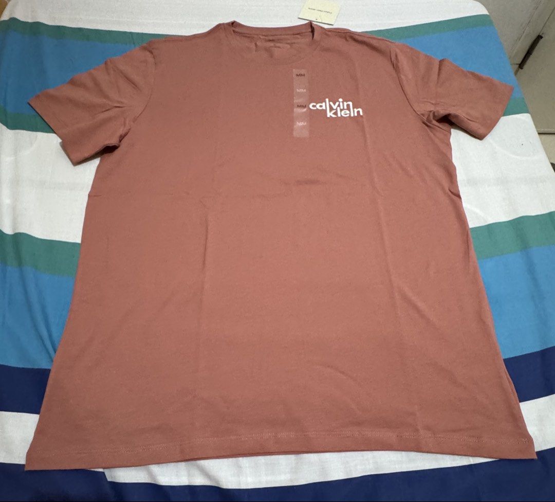 Calvin Klein Men Shirt (Category: Announcements) located in Quezon City. Submitted by branded_jo (Listing ID 1462050026, Image 2). Description: Original Calvin Klein Men Shirt Med in tag Color - Salmon Brand new with tag Bought in Canada Lalamove Ready.