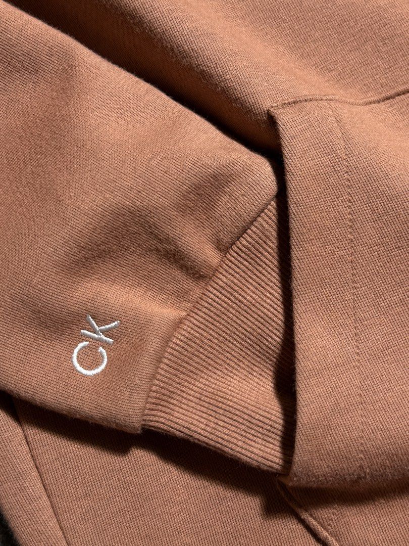 Calvin Klein Performance Hoodie - Brown - Size S (Category: Coats, Jackets and Outerwear) located in Cebu City. Submitted by stylehub_ (Listing ID 1462089551, Image 3). Description: - Brand: Calvin Klein Performance - Color: Brown - Style: Hoodie - Features: CK logo on sleeve - Material: Polyester and Cotton blend - Size: Tagged S -Dimension: 19.5 x 24.5 - Ideal for: Casual wear or workouts.