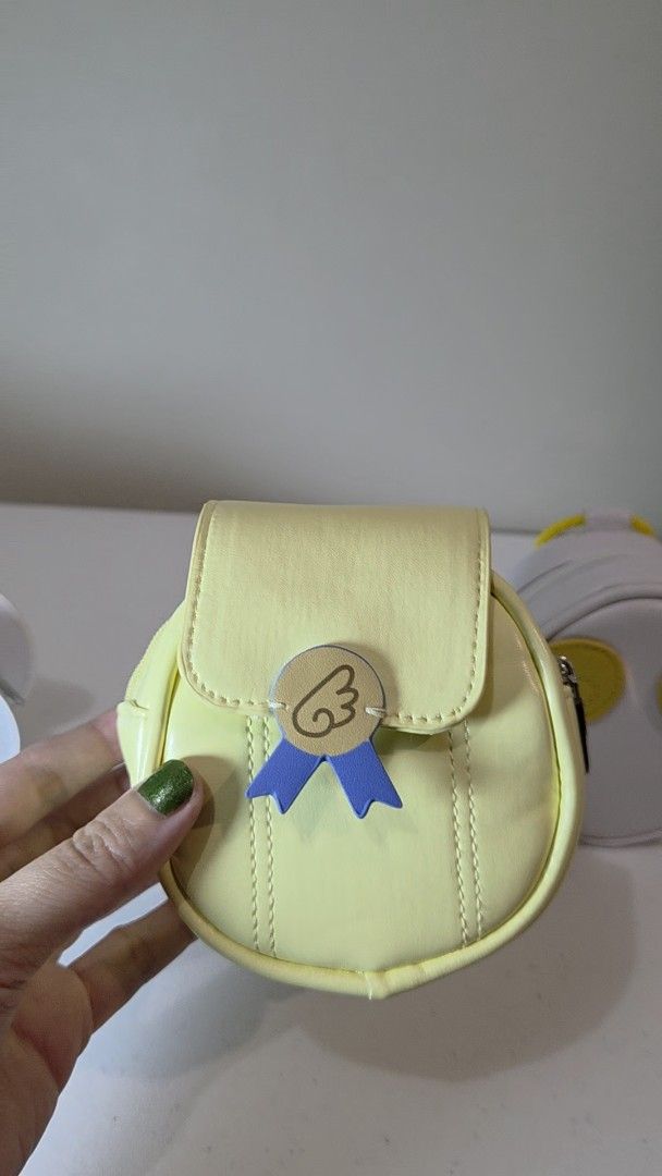 Cardcaptor Sakura GSC Earphone Case (Category: Purses & Pouches) located in Pasig City. Submitted by ccsakura4 (Listing ID 1462156372, Image 2). Description: - Adorable yellow coin purse - Round shape, easy to carry - Features a cute ribbon and wing charm - Secure zipper closure - Ideal for organizing small essentials - Compact size fits in pockets or small bags.