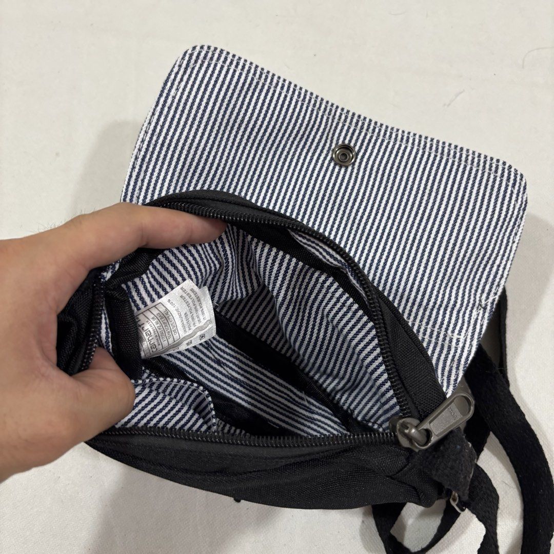 Carhartt Black Crossbody Bag (Category: Sling Bags) located in Cavite. Submitted by itsayaaa (Listing ID 1462093266, Image 3). Description: - Black Carhartt crossbody bag - Adjustable strap for comfortable wear - Main compartment with secure zipper closure - Interior features a stylish striped lining - Simple, functional, and great for everyday use - Perfectly fits your daily essentials.
