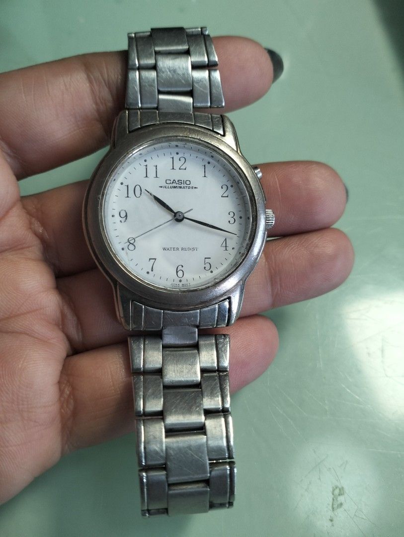 Casio Illuminator Water Resist Watch (Category: Men's Watches) located in General Mariano Alvarez. Submitted by ma.miafajardo1219 (Listing ID 1462053389, Image 3). Description: Casio watch with Illuminator and Water Resist features. Silver metal strap. The watch face is white with clear numbers. Some signs of wear on the metal strap and casing. Price tag shows 1200.sale now for only 1000.