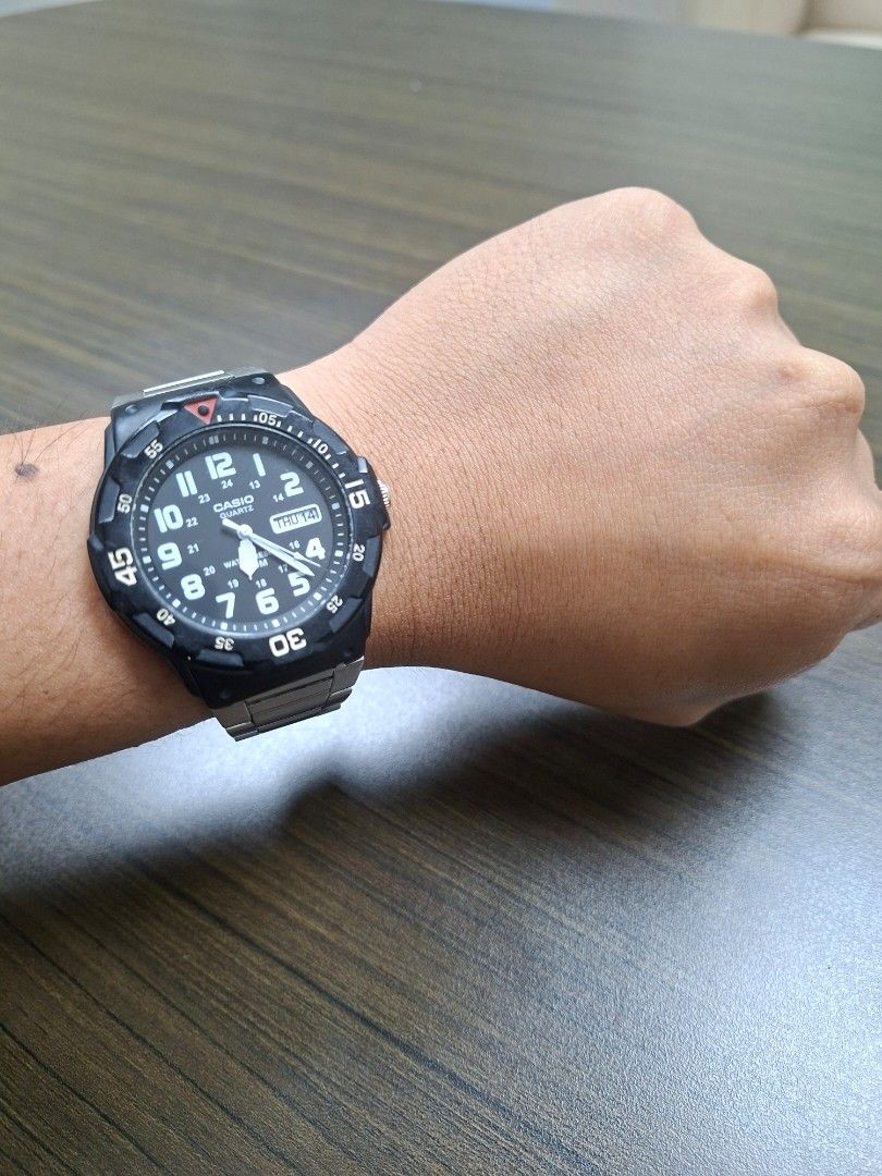 Casio MRW-200H (Category: Men's Watches) located in Quezon City. Submitted by fleetingticks (Listing ID 1462138458, Image 3). Description: Up for sale is a classic, highly reliable Casio MRW-200H analog sport watch. Featuring a high-contrast black dial with bold white Arabic numerals, this watch offers exceptional readability at a glance. It includes a functional day/date display and a sporty rotating bezel. It is paired with a durable, adjustabl