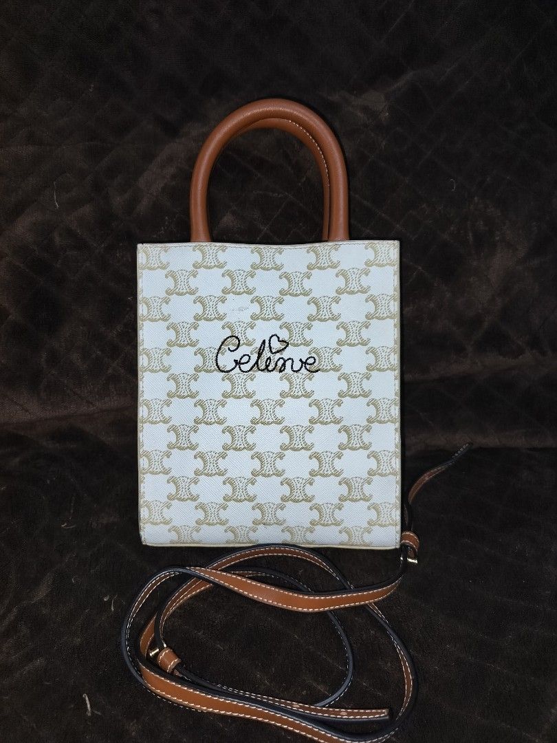 CELINE MINI VERTICAL CABAS 920 (Category: Luxury Bags & Wallets) located in Caloocan City. Submitted by jennielz (Listing ID 1462142924, Image 1). Description: CELINE MINI VERTICAL CABAS 920 special edition tote bag featuring white Triomphe canvas and an embroidered cursive logo with a heart. -made in italy -coded -good as new sling and some metal hardware are stil covered with protective plastic -over all the bag is in very good condition.