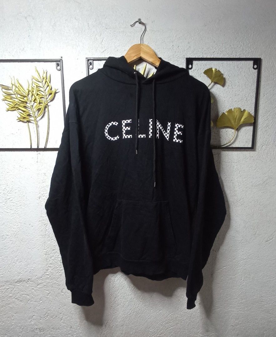 Celine Paris Hoodie (Category: Luxury Apparel) located in Kawit. Submitted by deidzdzn (Listing ID 1462100816, Image 2). Description: - Authentic Celine hoodie - Color: Black - Unique checkerboard rivet details on the front - Size on tag: S - Fits like an oversized XL - Measurements: Width 25 inches, Length 27 inches - Ideal for a relaxed and comfortable fit.