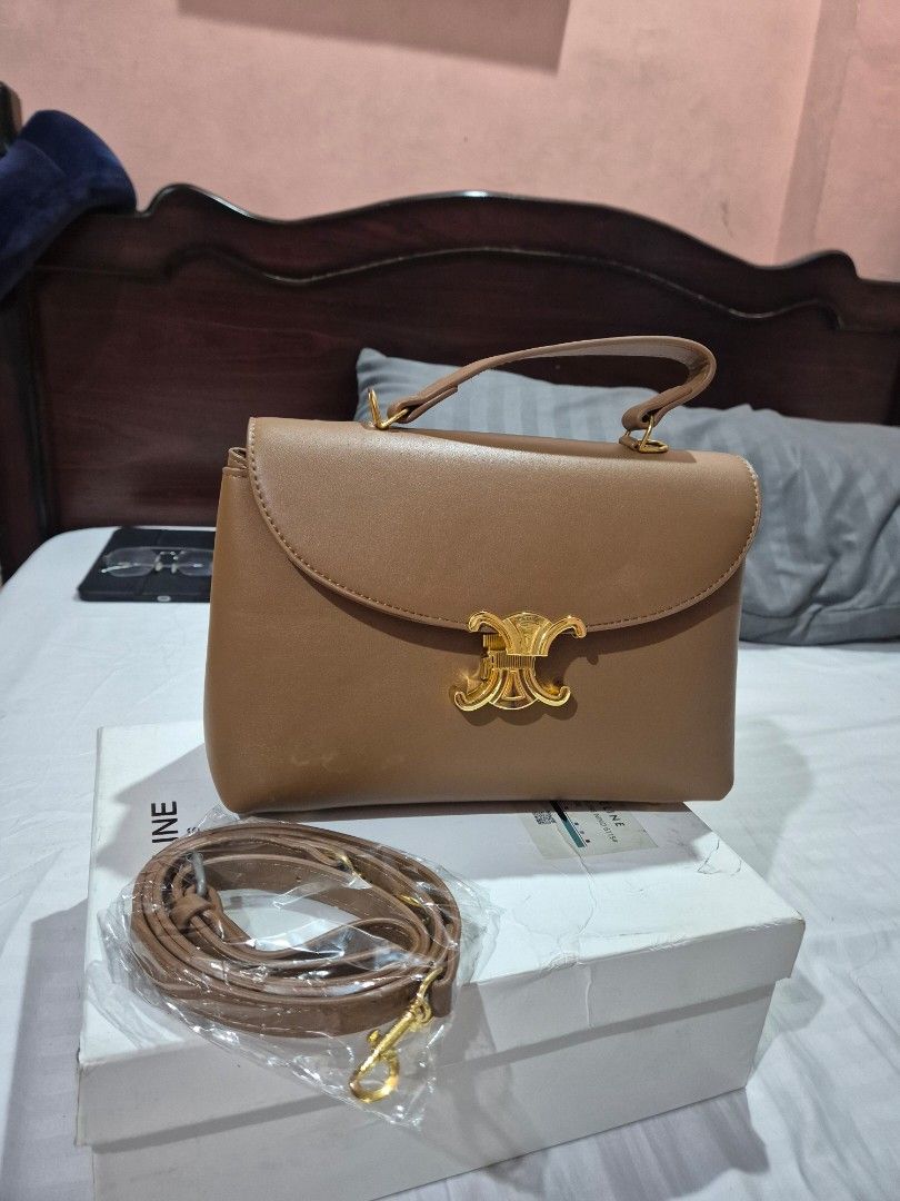 Celine Triomphe Shoulder Bag Brown Leather (Category: Luxury Bags & Wallets) located in Makati City. Submitted by amara78 (Listing ID 1462078807, Image 1). Description: FOR SALE: Celine Brown Bag 👜🤎 Selling my Celine brown leather bag — never been used, nakatambak lang sa storage. • Color: Brown • Material: Leather • Closure: Iconic gold Triomphe clasp • Features: Top handle + detachable strap • Includes: Original box • Condition: Never used • 