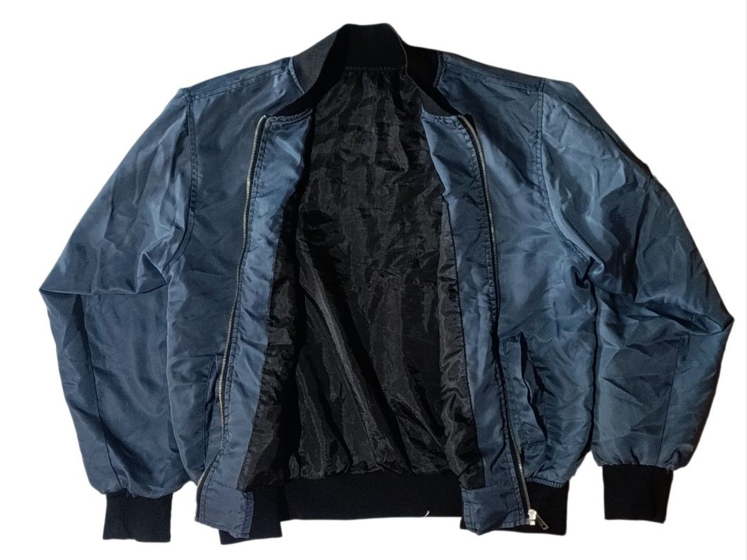 Champion Reversible Bomber Jacket Blue (Category: Coats, Jackets and Outerwear) located in General Santos City (Dadiangas). Submitted by jay_roa (Listing ID 1462118097, Image 2). Description: - Champion bomber jacket in a stylish blue color. - Features the iconic Champion logo prominently on the front. - Boasts a large Champion logo with Japanese text on the back for a unique look. - Convenient zipper closure for easy wear. - Ribbed cuffs and hem