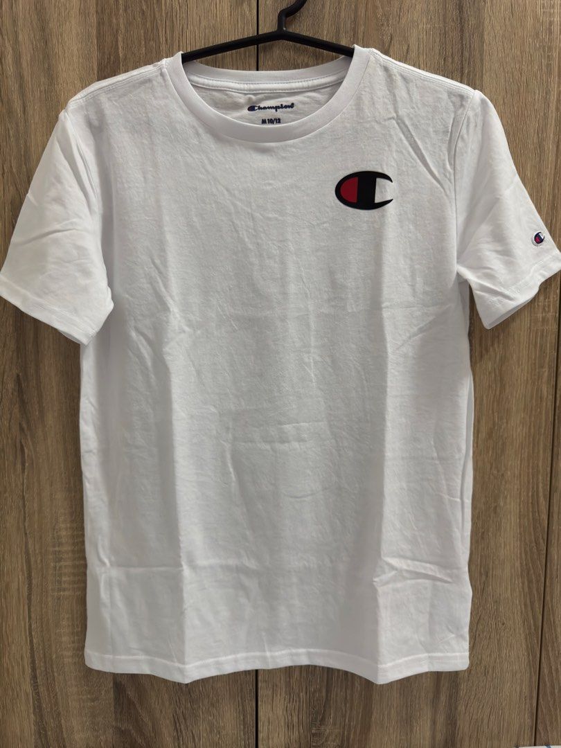 Champion White T-Shirt with Logo (Category: Tshirts & Polo Shirts ) located in Manila. Submitted by lawin1969 (Listing ID 1462037650, Image 2). Description: - Classic white Champion t-shirt - Features iconic C logo on chest - Smaller C logo on sleeve - Versatile and great for everyday wear - Size: Medium (fits 10/12).