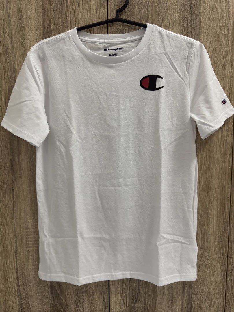 Champion White T-Shirt with Logo (Category: Tshirts & Polo Shirts ) located in Manila. Submitted by lawin1969 (Listing ID 1462037650, Image 3). Description: - Classic white Champion t-shirt - Features iconic C logo on chest - Smaller C logo on sleeve - Versatile and great for everyday wear - Size: Medium (fits 10/12).