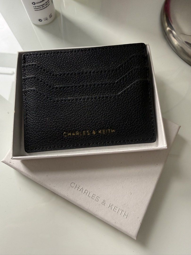 Charles & Keith Black Card Holder (Category: Wallets & Card holders) located in Manila. Submitted by smrev224 (Listing ID 1462053399, Image 1). Description: - Brand: Charles & Keith - Color: Black - Material: Textured Leather - Features: Multiple card slots - Includes: Original box - Benefit: Keeps your cards neatly organized.
