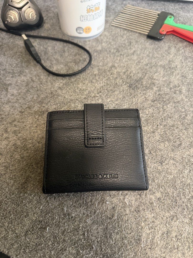 CHARLES & KEITH Black Leather Card Holder (Category: Wallets & Card holders) located in Manila. Submitted by caballeroa11402 (Listing ID 1462043997, Image 1). Description: - Brand: CHARLES & KEITH - Material: Black Leather - Features: Multiple card slots - Closure: Secure snap button - Size: Small and compact, fits easily in pockets or small bags - Ideal for: Everyday use.