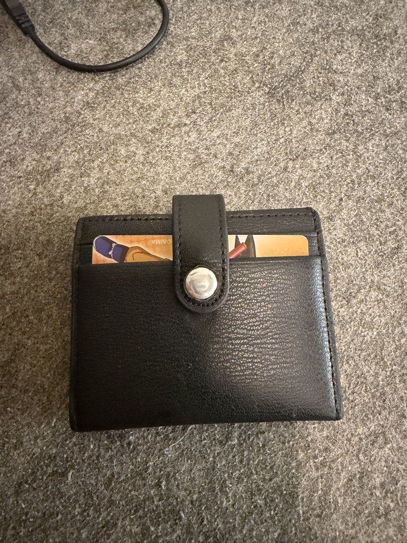 CHARLES & KEITH Black Leather Card Holder (Category: Wallets & Card holders) located in Manila. Submitted by caballeroa11402 (Listing ID 1462043997, Image 2). Description: - Brand: CHARLES & KEITH - Material: Black Leather - Features: Multiple card slots - Closure: Secure snap button - Size: Small and compact, fits easily in pockets or small bags - Ideal for: Everyday use.