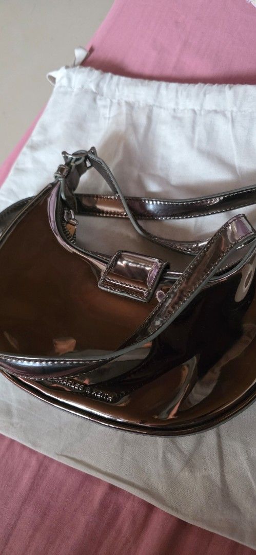 Charles & Keith Patent Shoulder Bag (Category: Shoulder Bags) located in Santa Maria. Submitted by ellahqy28 (Listing ID 1462191397, Image 1). Description: - Brand: Charles & Keith - Style: Shoulder Bag - Material: Shiny Patent - Color: Metallic Brown - Closure: Flap with silver buckle detail - Includes: Dust bag - Perfect for: Nights out, adding a pop to your outfit.