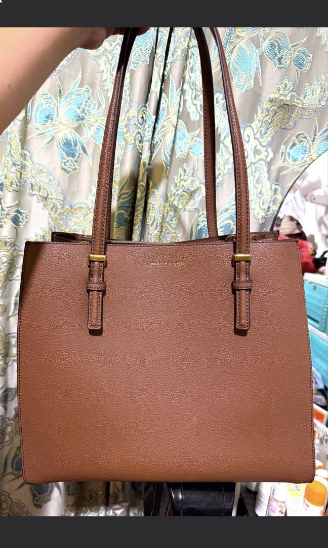 Charles & Keith Sansa Tote Bag - Chocolate (Category: Tote Bags) located in Quezon City. Submitted by miratrishxeanelle (Listing ID 1462192354, Image 1). Description: - Brand: Charles & Keith - Model: Sansa Tote Bag - Color: Chocolate Brown - Features: Spacious interior, zippered compartments, gold hardware details - Ideal for: Work, everyday use.