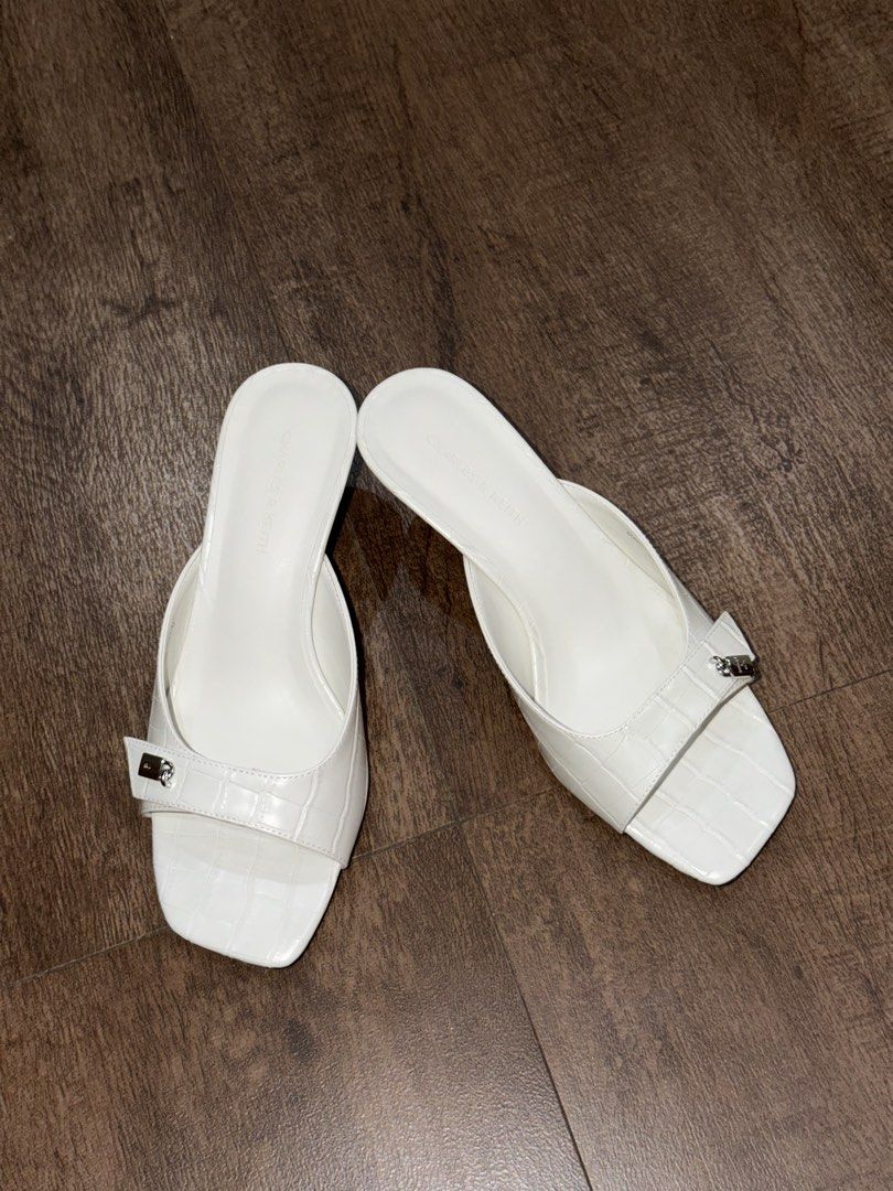 Charles & Keith White Croc Embossed Square Toe Mules Heels Size 36 (Category: Heels) located in Antipolo. Submitted by sugarpop.mnl (Listing ID 1462200341, Image 2). Description: - Brand: Charles & Keith - Color: White - Style: Mules - Size: 36 - Texture: Croc embossed - Design: Square toe with small silver buckle detail - Heel: Low heel, comfortable for walking - Condition: Comes with original box.