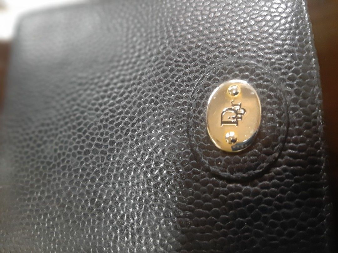 Christian Dior Black Leather Bifold Wallet (Category: Luxury Bags & Wallets) located in Bulacan. Submitted by edisoncert71953 (Listing ID 1462058837, Image 2). Description: - Authentic Christian Dior black leather bifold wallet - Multiple card slots and a coin pocket - Embossed Dior logo on the front - Christian Dior name embossed inside.