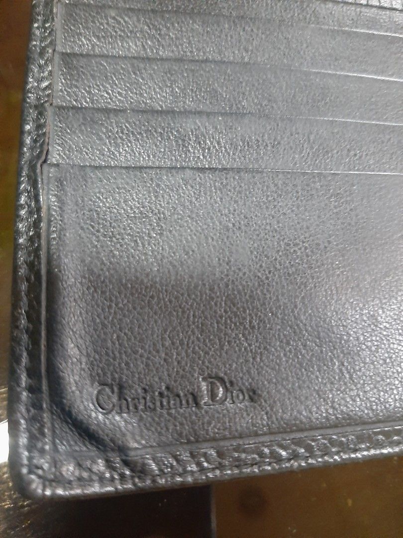 Christian Dior Black Leather Bifold Wallet (Category: Luxury Bags & Wallets) located in Bulacan. Submitted by edisoncert71953 (Listing ID 1462058837, Image 3). Description: - Authentic Christian Dior black leather bifold wallet - Multiple card slots and a coin pocket - Embossed Dior logo on the front - Christian Dior name embossed inside.