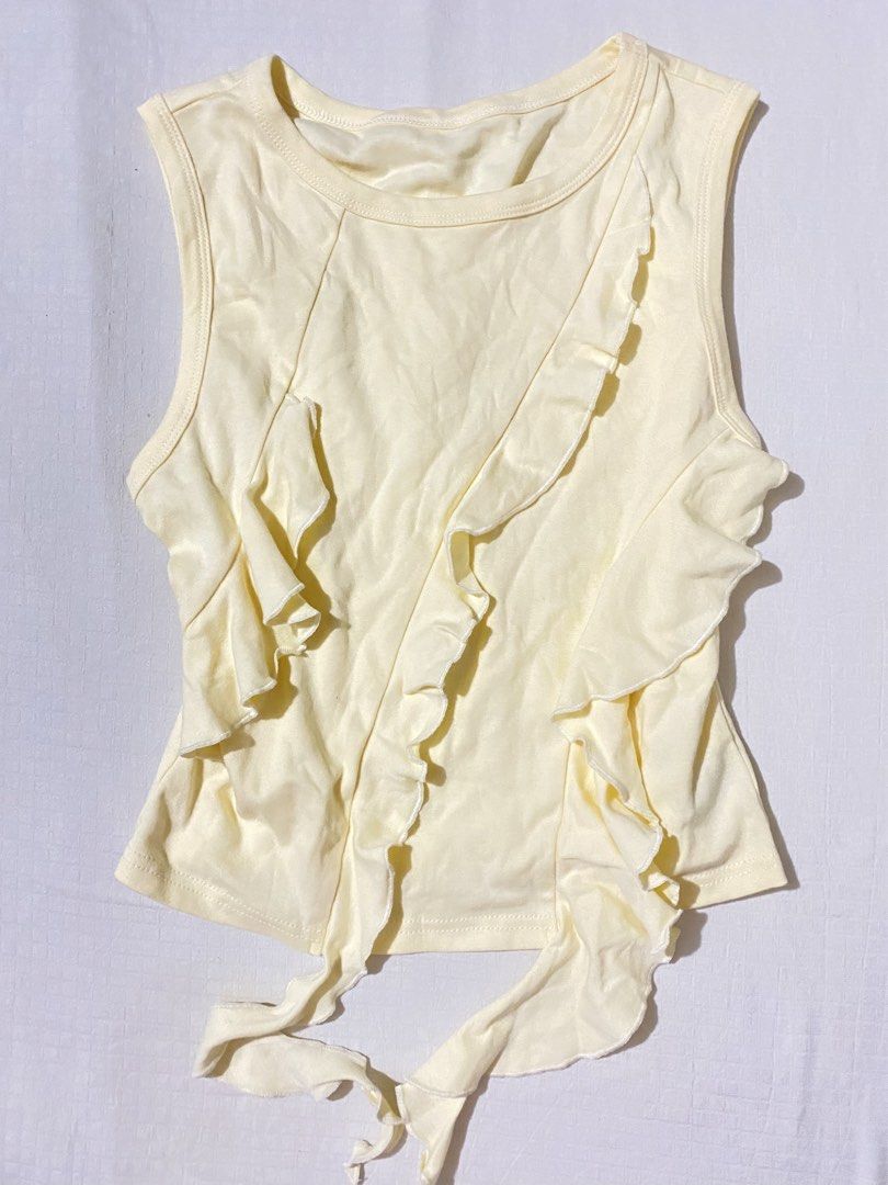 Cider Yellow Ruffle Tank Top (Category: Sleeveless) located in Quezon City. Submitted by getitrightaway.ph (Listing ID 1462174114, Image 1). Description: - Adorable yellow tank top from Cider - Features charming ruffles down the front - Stylish tie detail at the bottom hem - Sleeveless design for a breezy feel - Versatile for casual outings or dressing up - Size: Small (S).