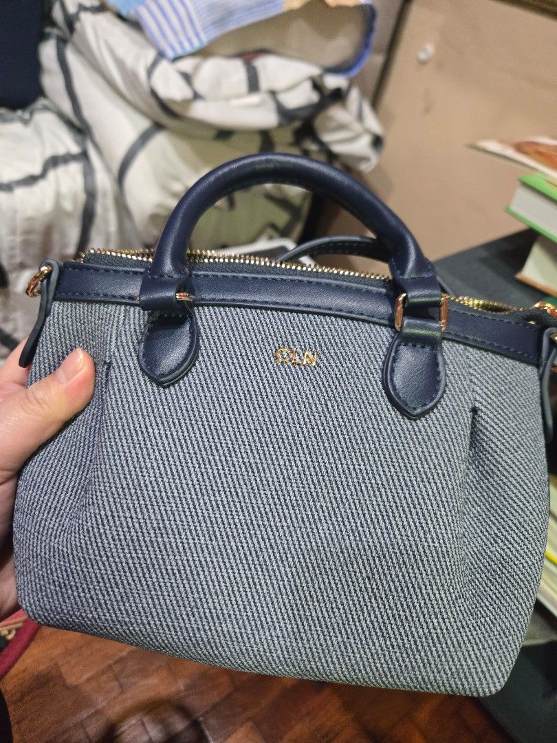 CLnNavy Denim Top Handle Bag (Category: Luxury Bags & Wallets) located in Quezon City. Submitted by mello_letgoes (Listing ID 1462180188, Image 2). Description: - Stylish navy denim handbag - Elegant leather trim - Shiny gold hardware details - Multiple interior compartments for organization - Secure zip pocket inside - Comes with original tag - Compact size: Approx. 25cm x 15cm x 12cm - Ideal for daily use and errands CLN ANDRELENE HANDBAG – NAV