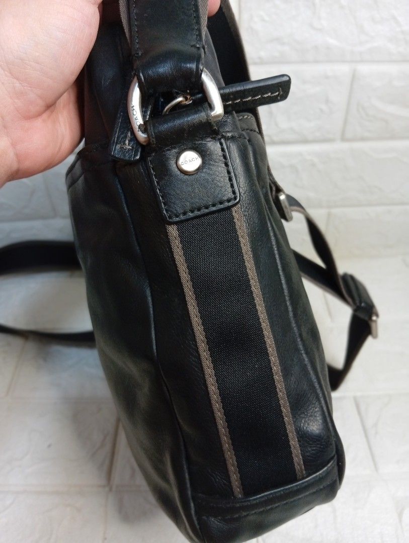 Coach Black Leather Crossbody Bag (Category: Luxury Bags & Wallets) located in Las Pinas. Submitted by etoksi1234 (Listing ID 1462127273, Image 3). Description: Pre-loved Coach leather crossbody bag. Features a front pocket, adjustable strap, and embossed logo. Stylish striped side detail. .