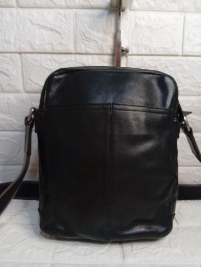 Coach Black Leather Crossbody Bag (Category: Luxury Bags & Wallets) located in Las Pinas. Submitted by etoksi1234 (Listing ID 1462127273, Image 2). Description: Pre-loved Coach leather crossbody bag. Features a front pocket, adjustable strap, and embossed logo. Stylish striped side detail. .