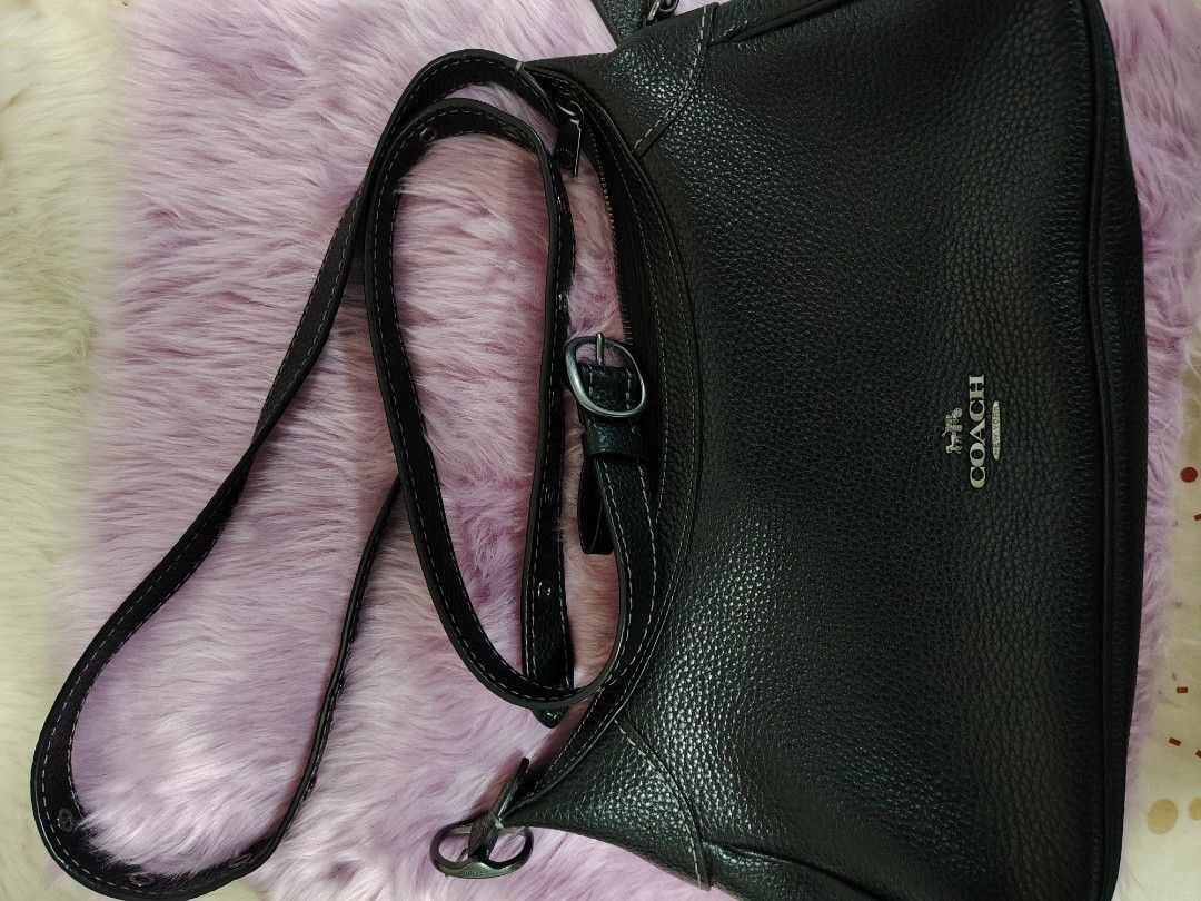 Coach Black Leather Shoulder Bag (Category: Luxury Bags & Wallets) located in Valenzuela. Submitted by glitter_preloved (Listing ID 1462123471, Image 1). Description: - Authentic Coach black pebbled leather shoulder bag - Sleek silver hardware details - Secure zip closure for the main compartment - Convenient interior pockets for organization - Adjustable strap for comfortable wear - Comes with original silica gel packets.