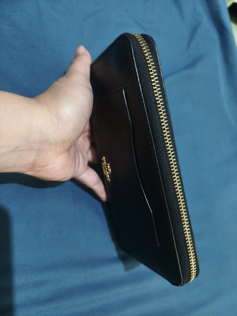 Coach Black Leather Zip Around Wallet (Category: Wallets & Card holders) located in Quezon City. Submitted by mikmik_ambo (Listing ID 1462171114, Image 2). Description: - Genuine Coach black leather wallet - Secure zip-around closure with gold zipper - Ample card slots and compartments for excellent organization - Elegant gold Coach logo detail - Practical size: approximately 7.5 inches long and 4 inches tall - From Japan not ukay.