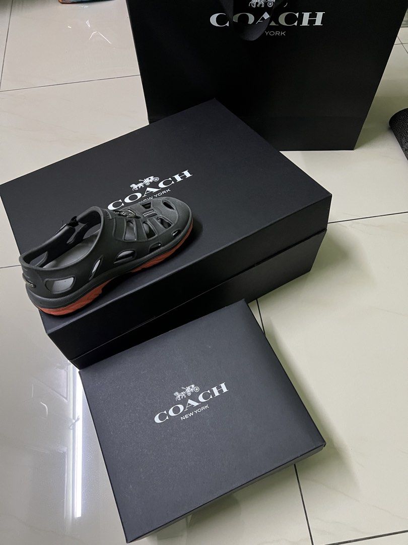 Coach box (Category: Accessories) located in Seri Kundang. Submitted by warmstone-dfaa (Listing ID 1462184708, Image 1). Description: - Authentic Coach kids sandals - Includes original Coach box and shopping bag - Ideal for beach or pool outings - Easy slip-on design for convenience - Features distinctive orange accents on the sole.