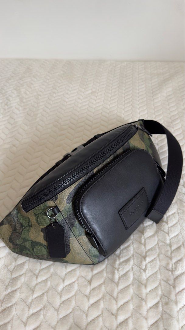 Coach Camo Leather Belt Bag (Category: Luxury Bags & Wallets) located in Pagsanjan. Submitted by mackadee (Listing ID 1462054974, Image 3). Description: - Authentic Coach Belt Bag - Stylish camouflage print with black leather details - Main zippered compartment for essentials - Additional front zippered pocket for quick access - Adjustable strap for comfortable wear - Ideal for travel, festivals, or everyday errands - Interior and exterior are cl