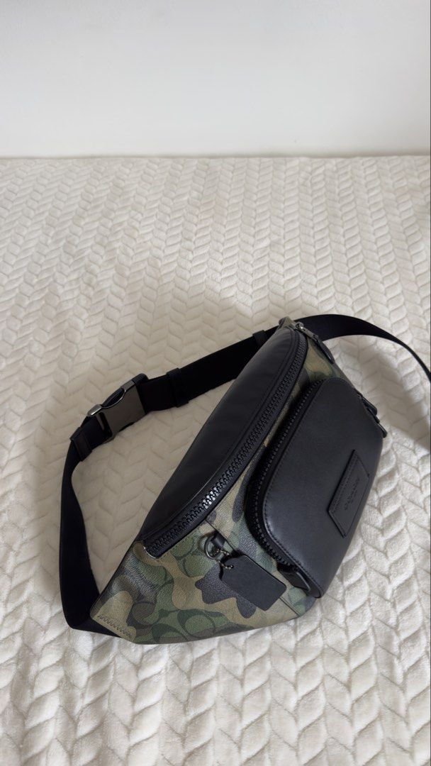Coach Camo Leather Belt Bag (Category: Luxury Bags & Wallets) located in Pagsanjan. Submitted by mackadee (Listing ID 1462054974, Image 2). Description: - Authentic Coach Belt Bag - Stylish camouflage print with black leather details - Main zippered compartment for essentials - Additional front zippered pocket for quick access - Adjustable strap for comfortable wear - Ideal for travel, festivals, or everyday errands - Interior and exterior are cl