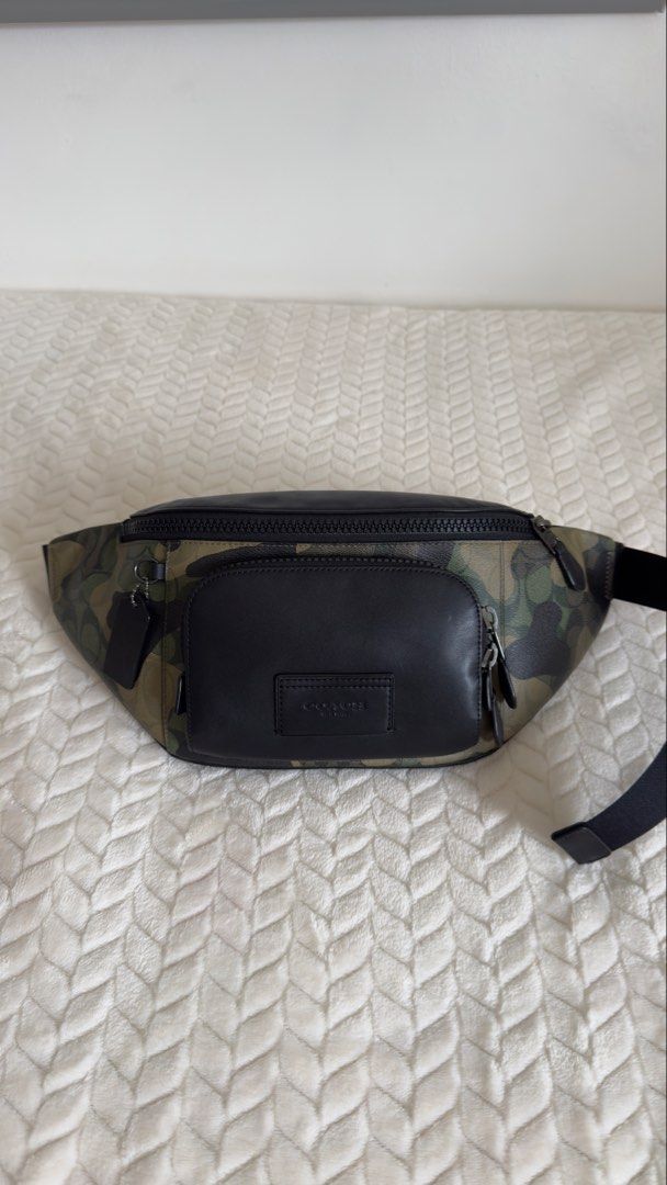 Coach Camo Leather Belt Bag (Category: Luxury Bags & Wallets) located in Pagsanjan. Submitted by mackadee (Listing ID 1462054974, Image 1). Description: - Authentic Coach Belt Bag - Stylish camouflage print with black leather details - Main zippered compartment for essentials - Additional front zippered pocket for quick access - Adjustable strap for comfortable wear - Ideal for travel, festivals, or everyday errands - Interior and exterior are cl