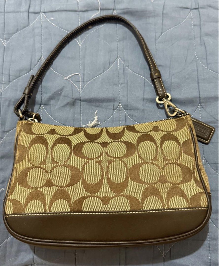Coach Demi Pochette in Brown (Category: Shoulder Bags) located in Manila. Submitted by diazangeli91556 (Listing ID 1462238056, Image 1). Description: Brown Signature Leather and Canvas Baguette (Sourced from Japan) Hardware: Silver Guaranteed Original Excellent Condition Minimal Used Lalamove or Meet up around Cubao.