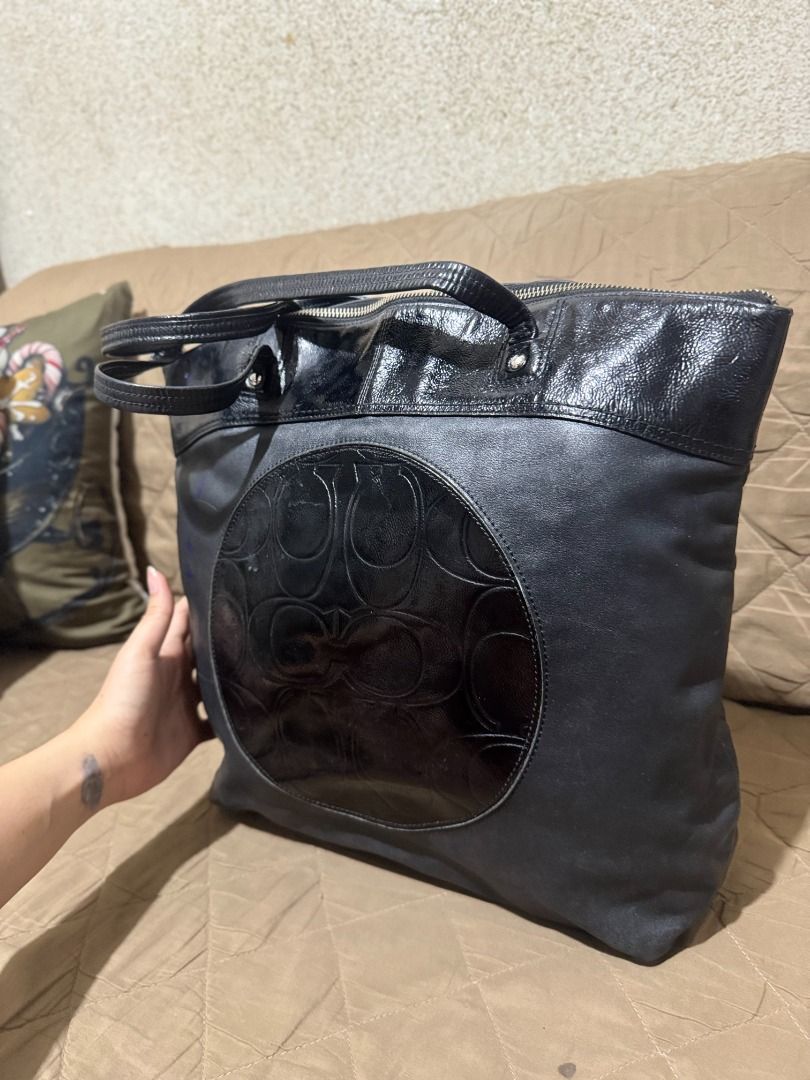 COACH LAURA TOTE (Category: Luxury Bags & Wallets) located in San Pablo. Submitted by calmhawk.60c993 (Listing ID 1462093451, Image 3). Description: a Coach Laura Signature Embossed Leather Tote, which stands out with its circular patent leather panel featuring the iconic embossed "C" signature pattern. this is authentic from canada pasalubong from my sister in law slightly used have minor issue like a blue stain coz my toddler loves to draw alam