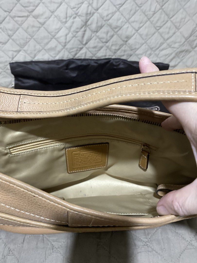 Coach Leather Hobo Bag with Dust Bag (Category: Luxury Bags & Wallets) located in Manila. Submitted by divinemercy_29 (Listing ID 1462132790, Image 2). Description: - Light tan pebbled leather Coach hobo bag - Front pocket with snap closure - Interior zip pocket - Comes with original Coach dust bag - Ideal for everyday use .