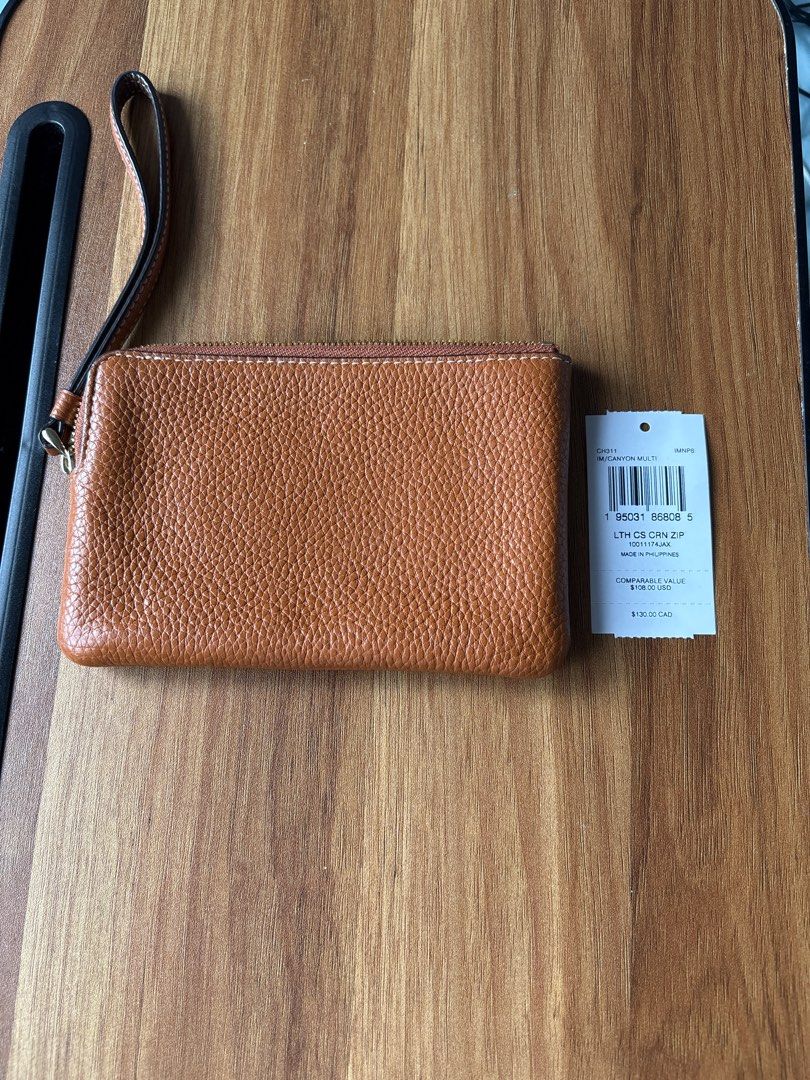 Coach LTH CS CRN ZIP Wristlet Pouch - Orange (Category: Purses & Pouches) located in Manila. Submitted by pugo_08_08_08 (Listing ID 1462045370, Image 2). Description: - Authentic Coach wristlet pouch - Vibrant orange pebbled leather - Stylish horizontal stripe design - Signature Coach logo on front - Secure zipper closure - Convenient wrist strap - Interior card slots for organization - Brand new with original tag attached - Proudly made in the P