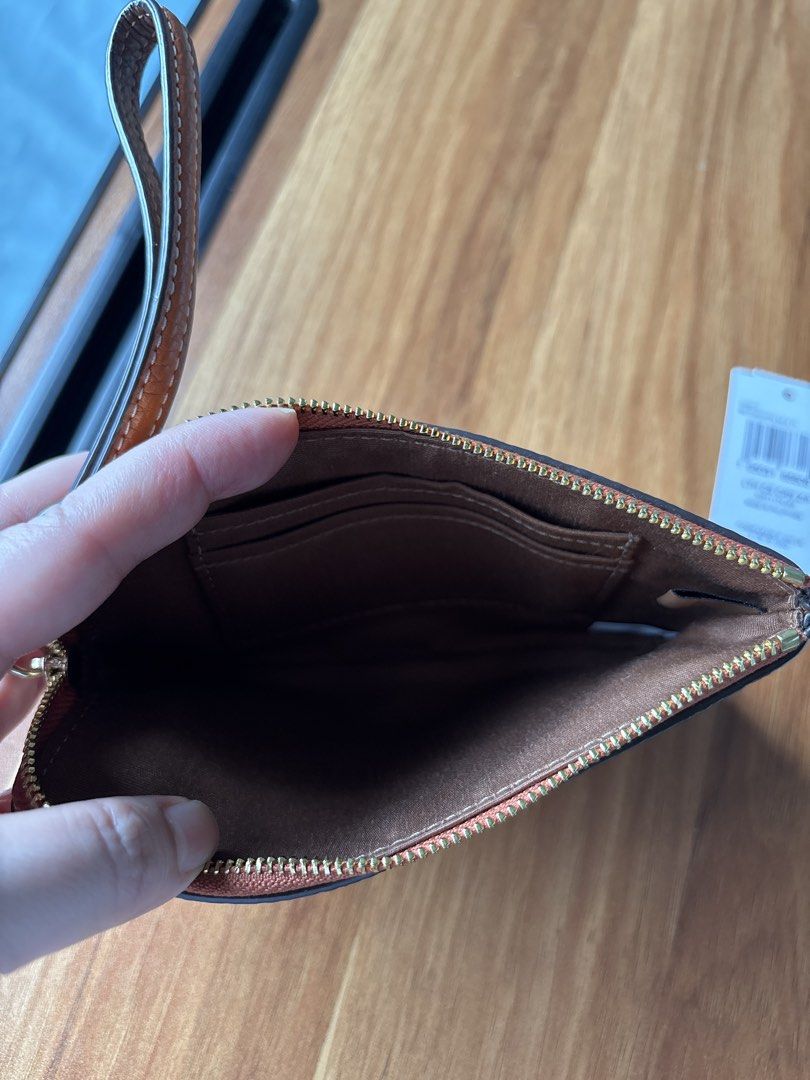 Coach LTH CS CRN ZIP Wristlet Pouch - Orange (Category: Purses & Pouches) located in Manila. Submitted by pugo_08_08_08 (Listing ID 1462045370, Image 3). Description: - Authentic Coach wristlet pouch - Vibrant orange pebbled leather - Stylish horizontal stripe design - Signature Coach logo on front - Secure zipper closure - Convenient wrist strap - Interior card slots for organization - Brand new with original tag attached - Proudly made in the P