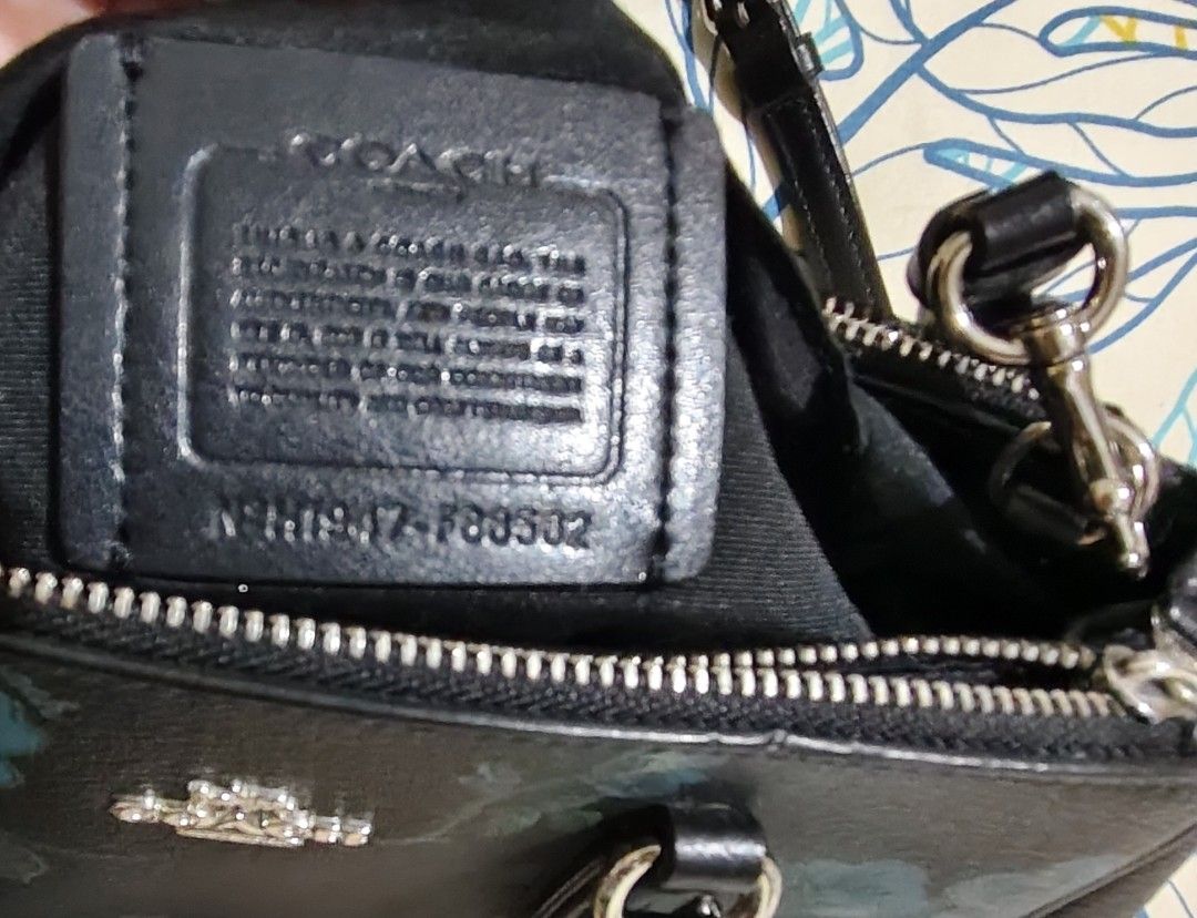 Coach mini Surrey floral blue black multi bag (Category: Shoulder Bags) located in Pasig City. Submitted by serrancr (Listing ID 1462170515, Image 3). Description: - Stylish black Coach satchel - Pretty blue floral print - Top handles for easy carrying - Detachable crossbody strap for versatility - Secure zipper closure - Interior lined with black fabric - Comes with original Coach hangtag - Proudly made in the Philippines - Ideal for everyday us
