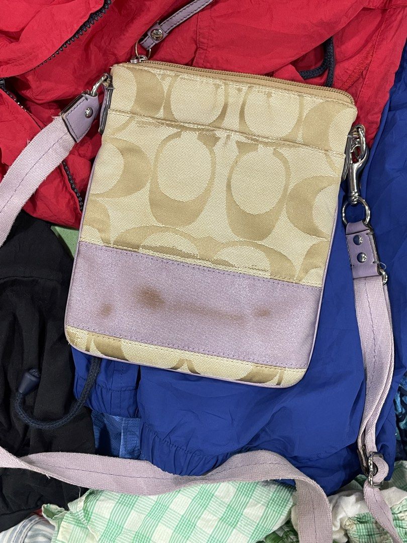 Coach Monogram Canvas & Leather Crossbody Bag (Category: Cross-body Bags) located in Lapu Lapu. Submitted by ruby_welly22 (Listing ID 1462177750, Image 1). Description: - Coach monogram canvas crossbody bag - Color: Tan and beige with light purple accents - Condition: Small stain on the front purple stripe - Closure: Zipper - Strap: Adjustable - Origin: Made in Vietnam - Ideal for: Everyday use.