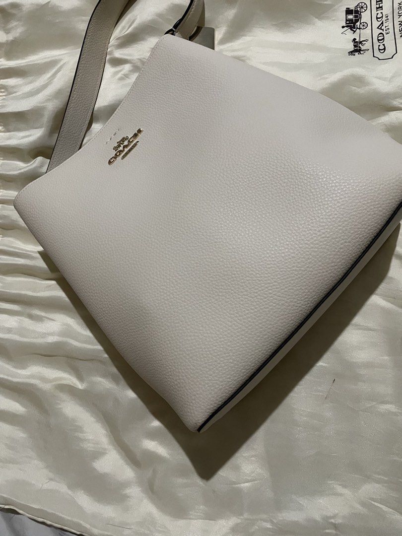 White Coach Pebble Leather Shoulder Bag (Category: Luxury Bags & Wallets) located in Manila. Submitted by real17 (Listing ID 1462117392, Image 3). Description: - Coach white pebble leather shoulder bag - Classic and simple design - Gold hardware details - Spacious interior - Comes with original dust bag - Ideal for everyday use Excellent brand new condition. super nice in actual PAYMENT FIRST BEFORE BOOKING. DONT BUY IF IN DOUBT. THIS IS AUTHENTI