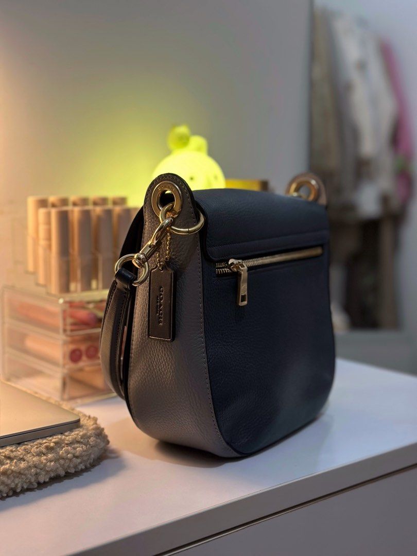 Coach Pebble Leather Shoulder Bag (Category: Luxury Bags & Wallets) located in Manila. Submitted by tinne15 (Listing ID 1462170742, Image 2). Description: - Brand: Coach - Material: Navy Blue pebbled leather - Hardware: Gold-tone - Compartments: Main zip compartment, interior pockets - Strap: Adjustable shoulder strap - Features: Coach hangtag - Ideal for: Everyday use.