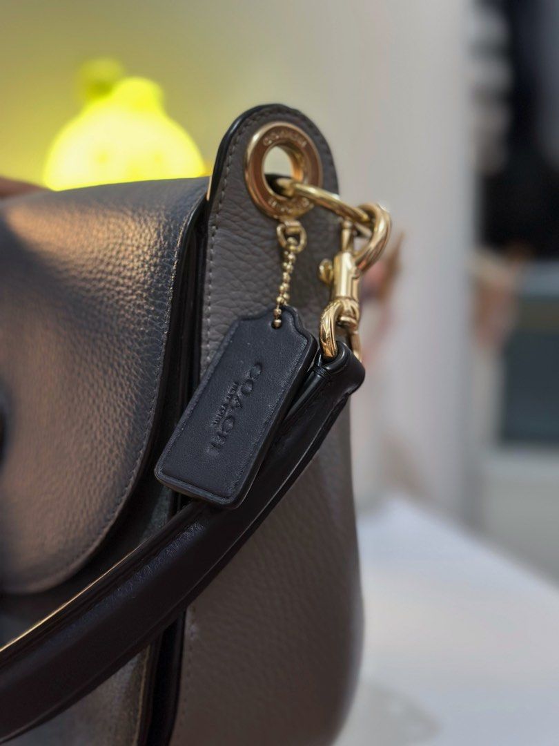 Coach Pebble Leather Shoulder Bag (Category: Luxury Bags & Wallets) located in Manila. Submitted by tinne15 (Listing ID 1462170742, Image 3). Description: - Brand: Coach - Material: Navy Blue pebbled leather - Hardware: Gold-tone - Compartments: Main zip compartment, interior pockets - Strap: Adjustable shoulder strap - Features: Coach hangtag - Ideal for: Everyday use.