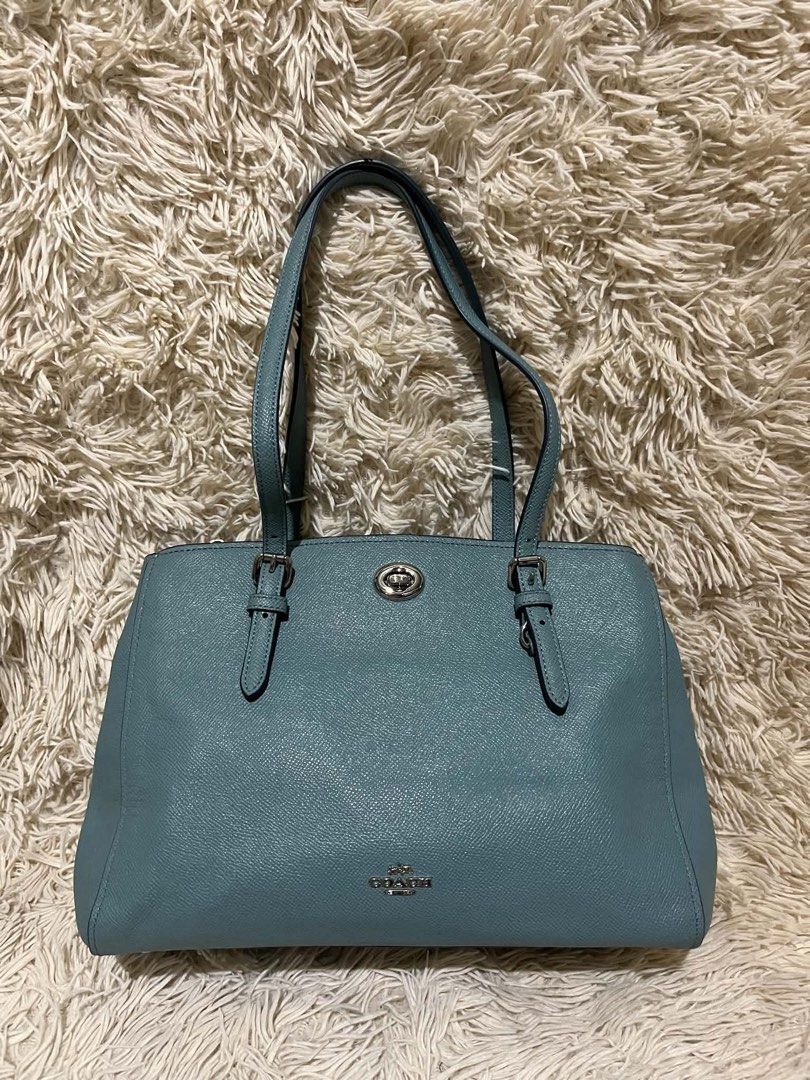 Coach Pebble Leather Tote Bag Teal (Category: Luxury Bags & Wallets) located in Kabankalan. Submitted by miaangelar73343 (Listing ID 1462168725, Image 1). Description: - Coach teal pebble leather tote bag - Silver hardware details - Main zip compartment with interior pockets - Top handles with adjustable buckle straps - Clean interior - Great everyday bag.