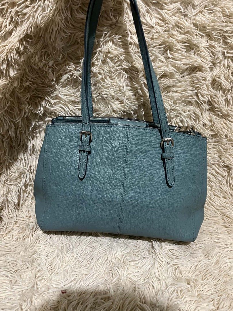 Coach Pebble Leather Tote Bag Teal (Category: Luxury Bags & Wallets) located in Kabankalan. Submitted by miaangelar73343 (Listing ID 1462168725, Image 2). Description: - Coach teal pebble leather tote bag - Silver hardware details - Main zip compartment with interior pockets - Top handles with adjustable buckle straps - Clean interior - Great everyday bag.