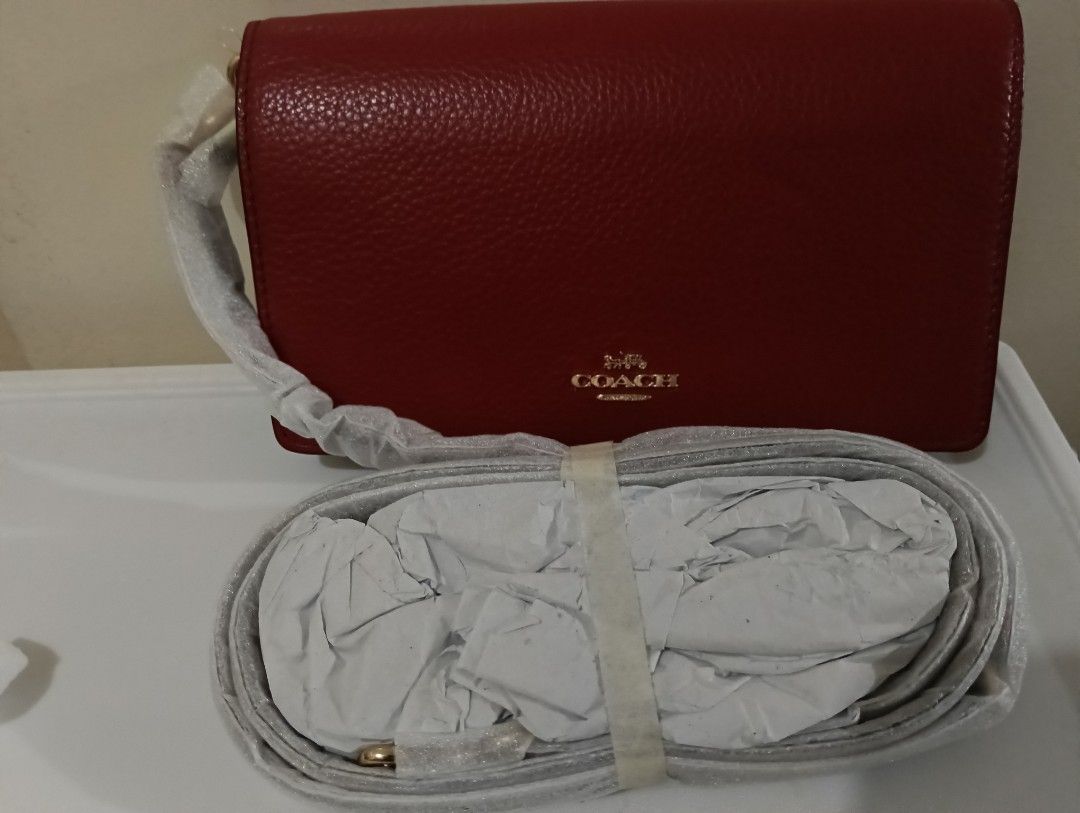 Coach Red Leather Crossbody Bag with Strap (Category: Cross-body Bags) located in Quezon City. Submitted by swiftcloud_070a6b (Listing ID 1462155588, Image 1). Description: - Authentic Coach red leather crossbody bag - Elegant gold hardware details - Multiple interior card slots for organization - Secure zippered compartment for essentials - Detachable strap for versatile wear (crossbody or clutch) - Ideal for everyday errands or a stylish night 