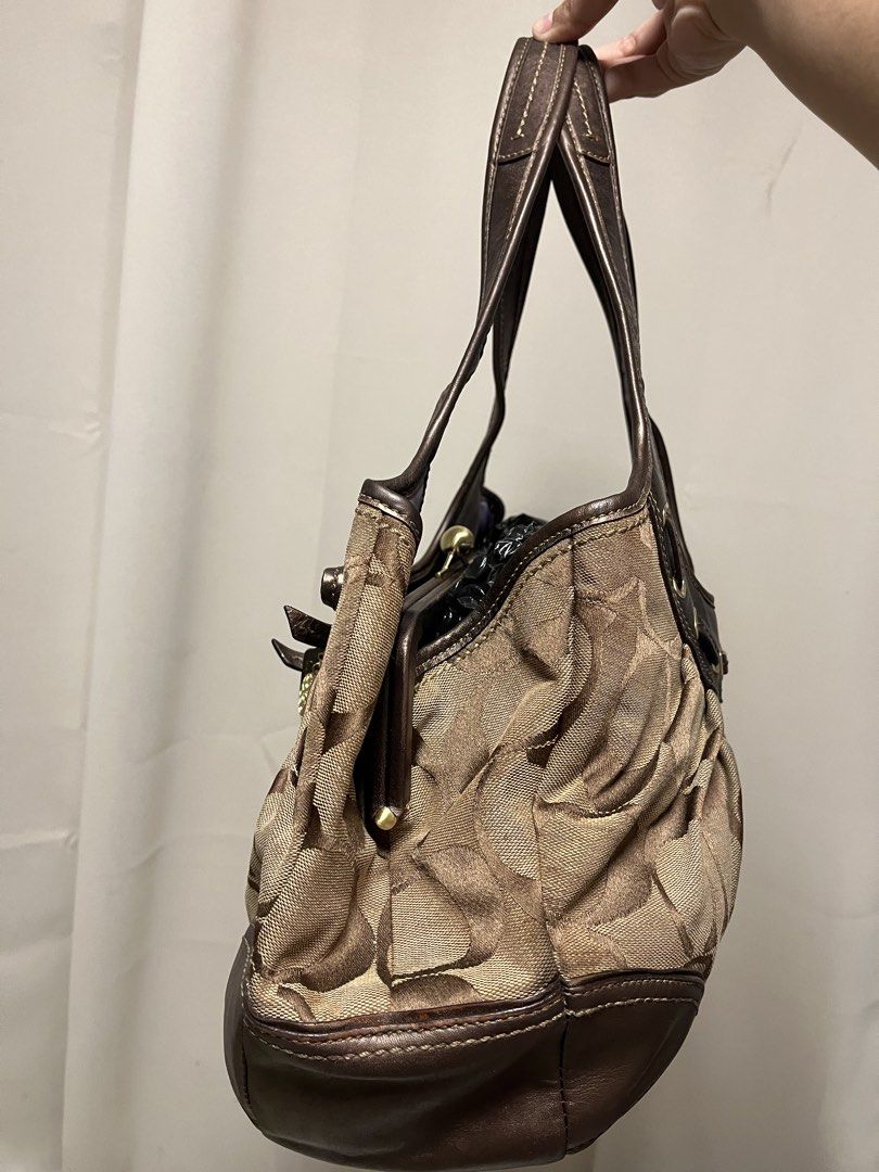 sold (Category: Luxury Bags & Wallets) located in Cabanatuan. Submitted by designerdepot.c (Listing ID 1462164874, Image 2). Description: - Coach hobo bag in signature C monogram print - Color: Brown and tan canvas with metallic bronze leather trim - Features a drawstring detail with a small bow and charm - Top handle for comfortable carrying - Interior zip pocket for essentials - Ideal everyday bag -discoloration issues -faded issues.