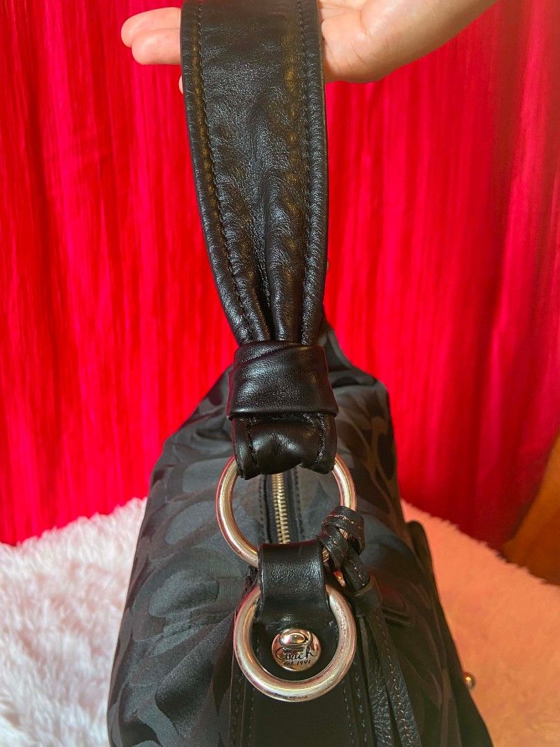 Coach Signature Monogram Hobo Bag (Category: Luxury Bags & Wallets) located in Bulacan. Submitted by bella.ken.varietystore (Listing ID 1462179813, Image 3). Description: - Authentic Black Coach Hobo Bag - Signature 'C' Monogram Pattern - Genuine Leather Straps and Trim - Front Flap Pocket with Turn-Lock Closure - Decorative Side Tassels - Spacious Interior - Ideal for Everyday Essentials - Versatile and Stylish for Daily Wear.